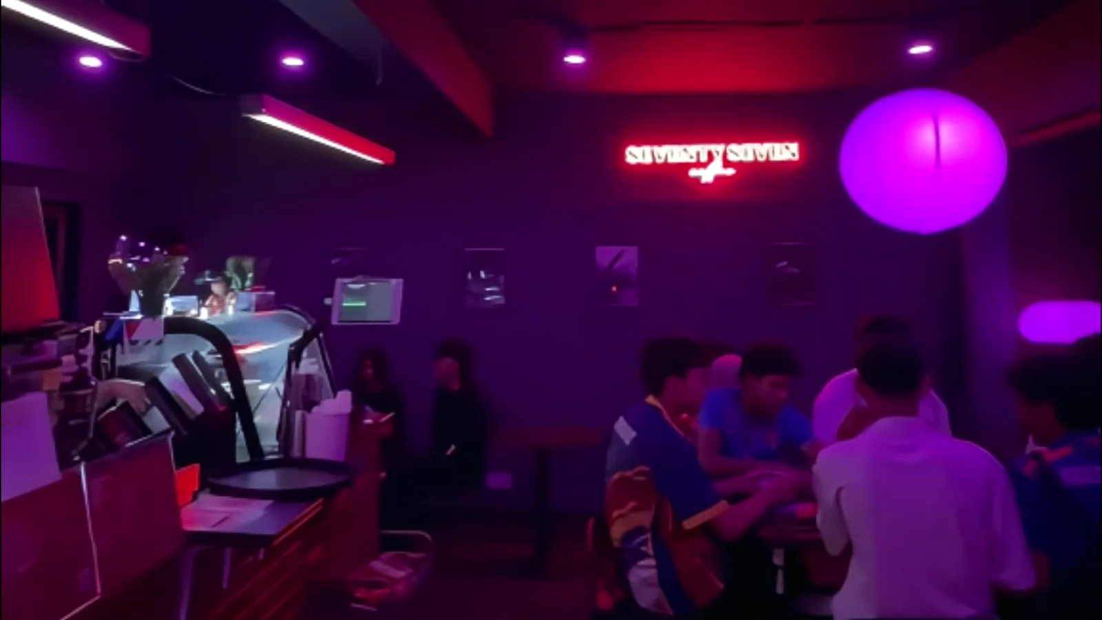 The bar at Seventy7 Coffee under purple light